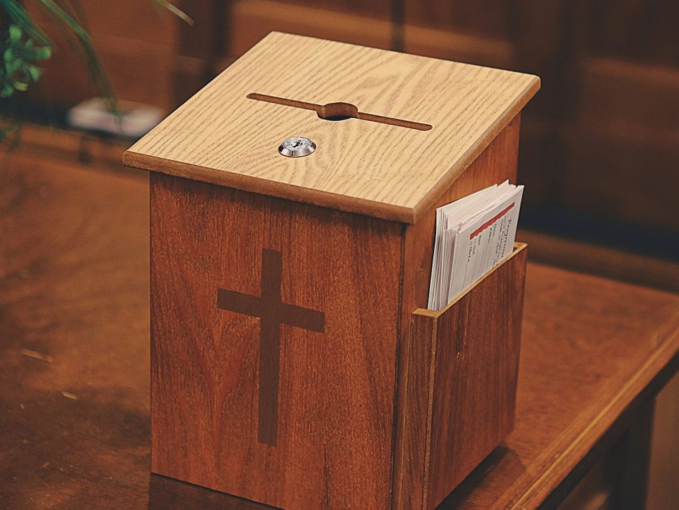 a wooden church offering box suggesting the ease of church embezzlement - U.S.S catholic