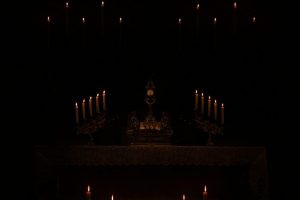 a-host-ina-monstrance-lit-by-candles