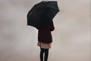 woman-standing-with-umbrella