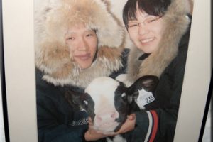 two-people-holding-baby-cow