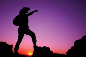 silhouette-of-woman-climbing-on-rock