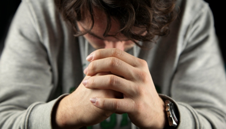 man-folding-hands-in-prayer