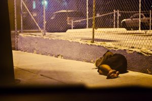 homeless-person-sleeping-on-sidewalk