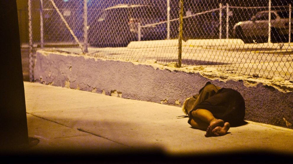 homeless-person-sleeping-on-sidewalk