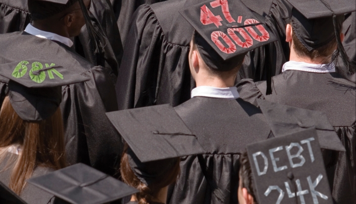graduates-with-debt-prices-written-on-their-caps