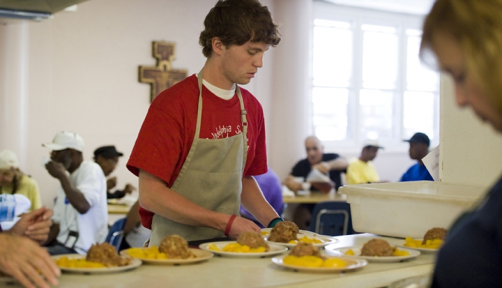man-handing-out-food-at-soup-kitchen