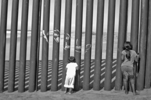 immigrant-children-looking-through-fence