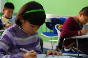 Chinese-child-writing-at-desk