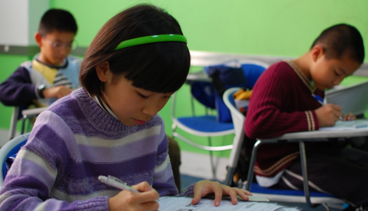 Chinese-child-writing-at-desk