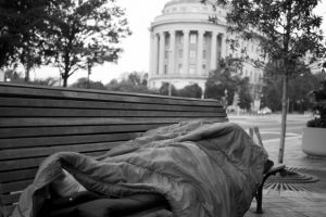 homeless-person-sleeping-on-bench