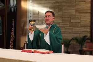 priest-holding-eucharist
