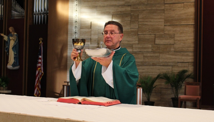 priest-holding-eucharist