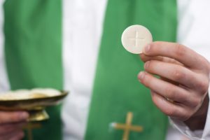 priest-holding-communion-wafer