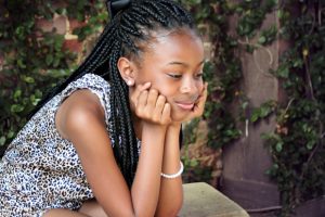 young-black-girl-with-head-in-hands