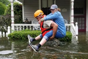 responder-carrying-woman-through-flood