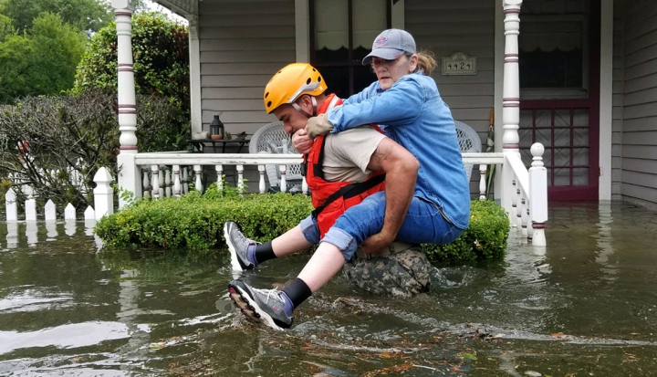 responder-carrying-woman-through-flood