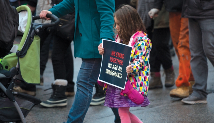 young-girl-at-rally-holding-sign-for-immigration