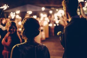 bride-and-groom-facing-crowd-with-candles