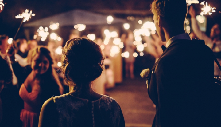 bride-and-groom-facing-crowd-with-candles