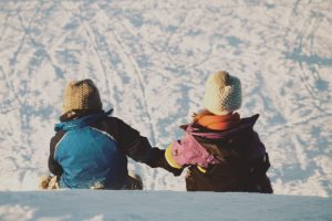 two-children-sledding