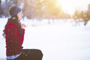 woman-kneeling-to-pray-in-snow