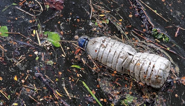 plastic-bottle-buried-in-dirt