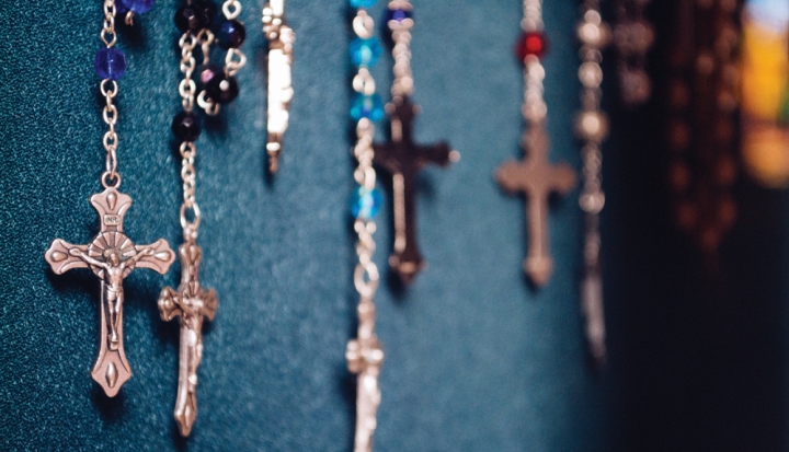 rosaries-hanging-against-blue-wall