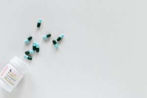 blue-green-pills-on-white-table
