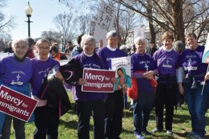 sisters-of-mercy-holding-protest-signs