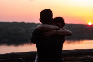 man-and-woman-hug-at-sunset