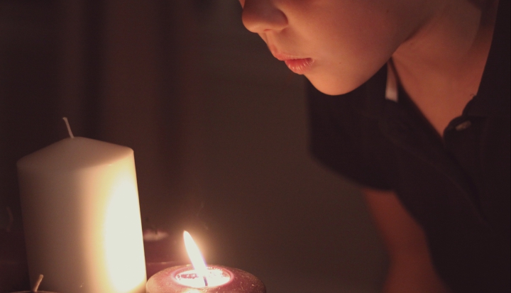 child-holding-candle