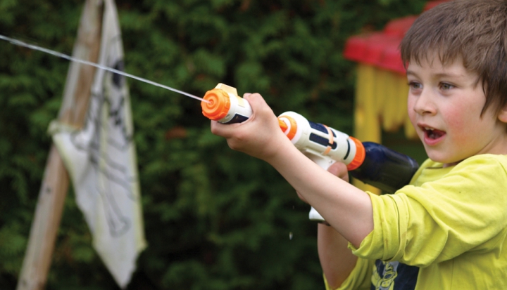 child-playing-with-water-gun