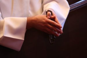clergyman-praying-rosary