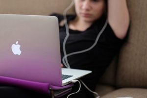 teenager-looks-at-laptop-screen