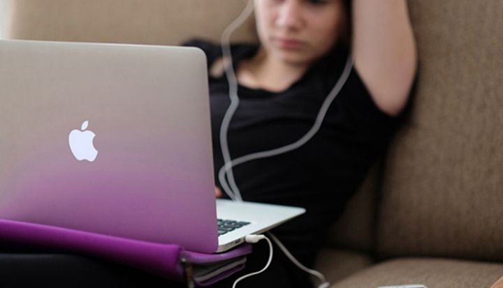 teenager-looks-at-laptop-screen