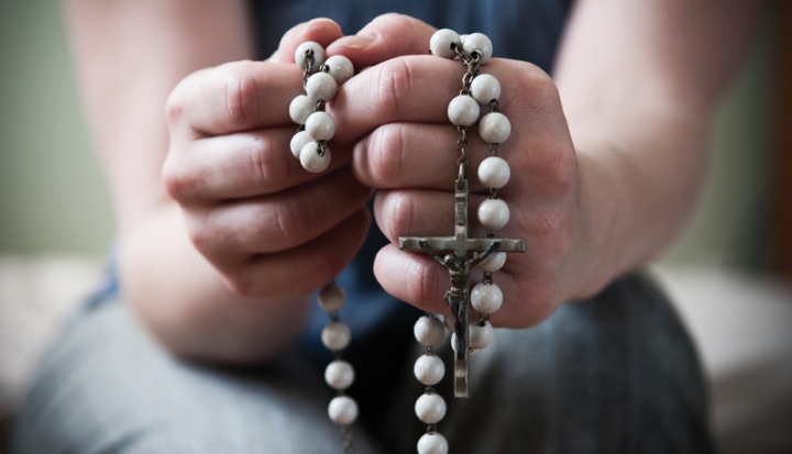 hands-holding-rosary-beads