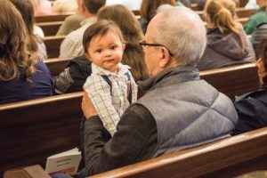 man-holding-baby-in-pew