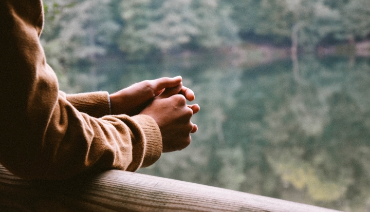 hands-folded-in-prayer-by-window