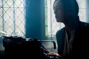person-sitting-at-typewriter