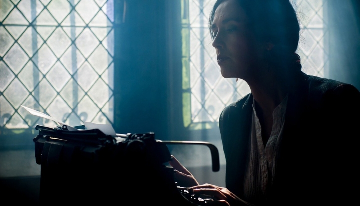 person-sitting-at-typewriter