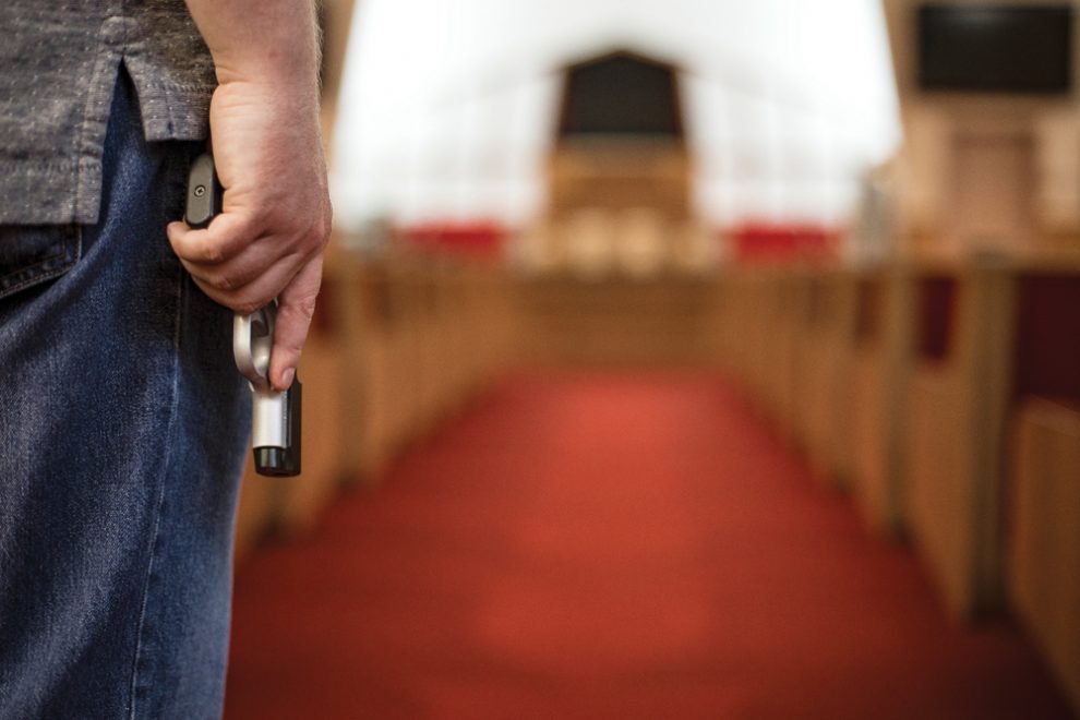 hand-holding-gun-in-church