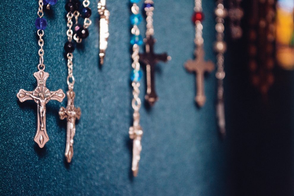 rosary-beads-against-blue-wall