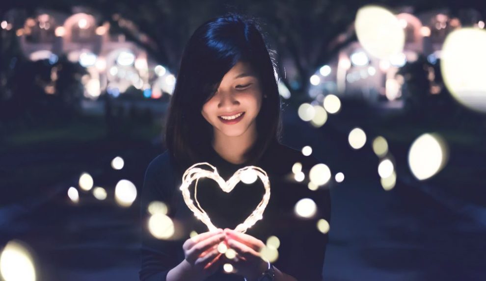 woman-holding-heart-made-of-light