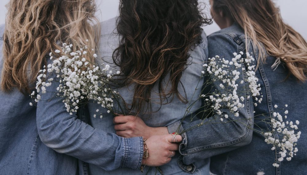 women-with-flowers-embracing