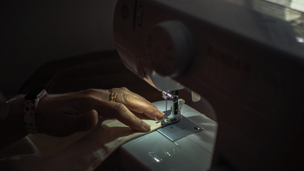 hands-using-sewing-machine