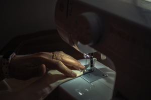 hands-using-sewing-machine