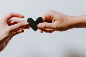 two hands-holding-paper-heart