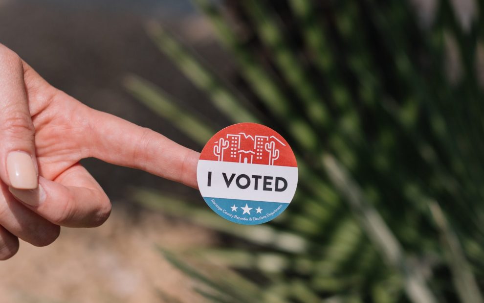 hand-holds-voting-sticker