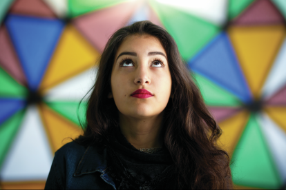 woman in front of stained glass