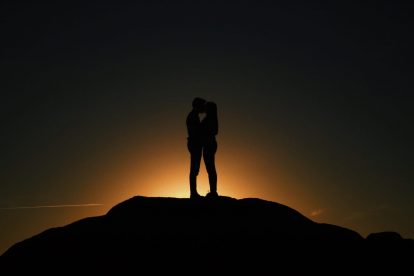a man and woman at sunset
